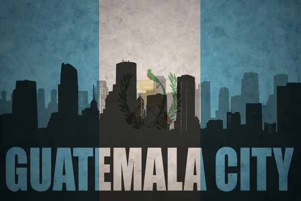 Abstract silhouette of the city with text Guatemala City at the vintage guatemalan flag — Stock fotografie