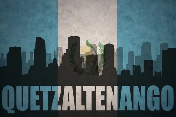 Abstract silhouette of the city with text Quetzaltenango at the vintage guatemalan flag — Stock fotografie