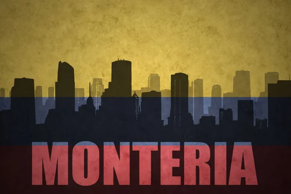 Abstract silhouette of the city with text Monteria at the vintage colombian flag — Stock Photo, Image