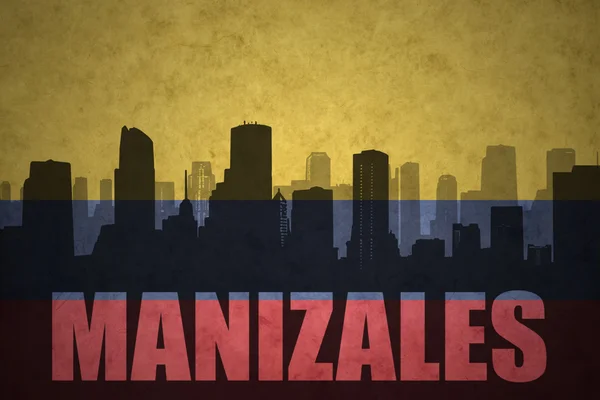 Abstract silhouette of the city with text Manizales at the vintage colombian flag — Stock Photo, Image