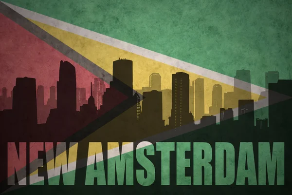 Abstract silhouette of the city with text New Amsterdam at the vintage guyana flag — Stockfoto