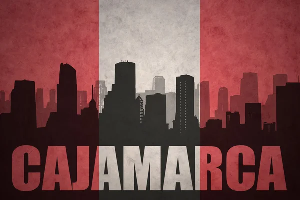 Abstract silhouette of the city with text Cajamarca at the vintage peruvian flag — Stock fotografie