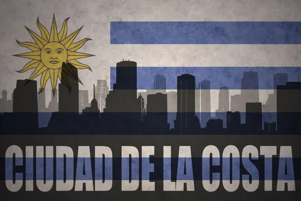 Silueta abstracta de la ciudad con texto Ciudad de la Costa en la bandera uruguaya de época —  Fotos de Stock