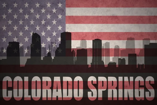 Abstract silhouette of the city with text Colorado Springs at the vintage american flag — Stock Photo, Image