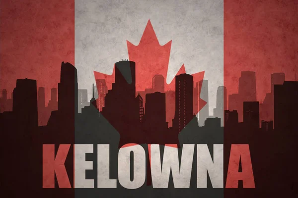 Abstrakta silhuetten av staden med text Kelowna på vintage kanadensiska flaggan — Stockfoto
