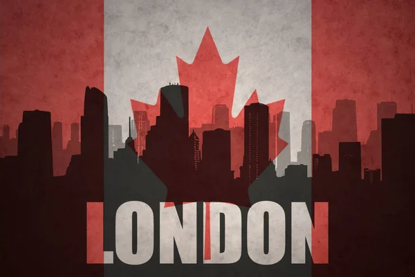 Abstraktní silueta města s textem Londýn na vinobraní kanadské vlajky — Stock fotografie