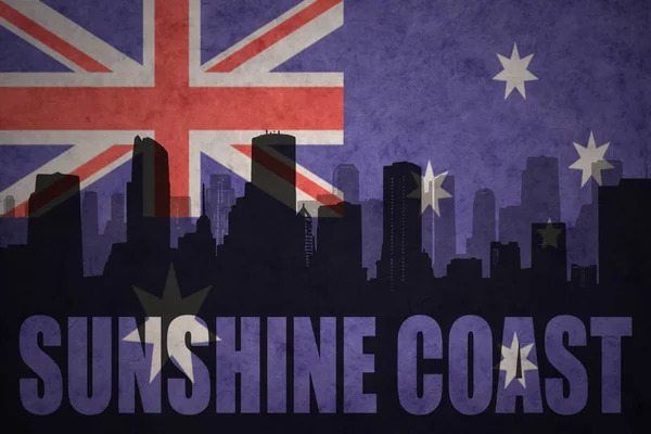Abstract silhouette of the city with text Sunshine Coast at the vintage australian flag — Stock Photo, Image