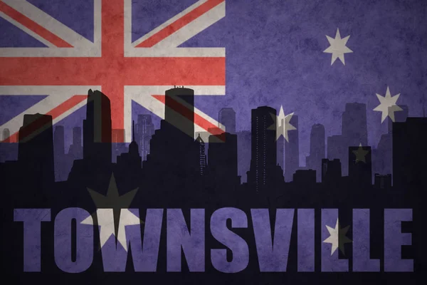 Abstract silhouette of the city with text Townsville at the vintage australian flag — Stock Photo, Image