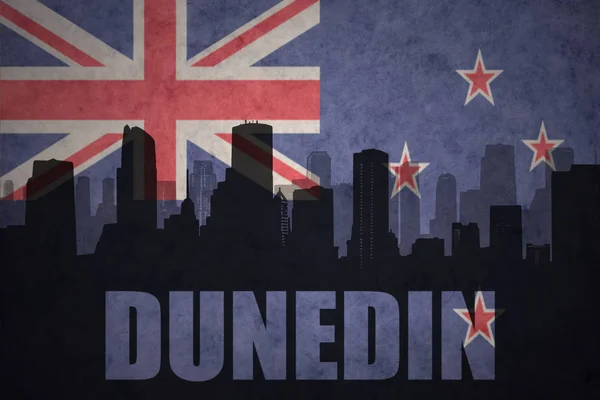 Abstract silhouette of the city with text Dunedin at the vintage new zealand flag — Stock Photo, Image