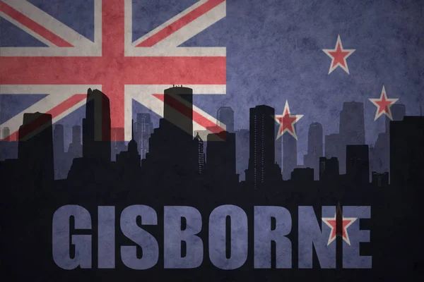 Abstract silhouette of the city with text Gisborne at the vintage new zealand flag — Stock Photo, Image