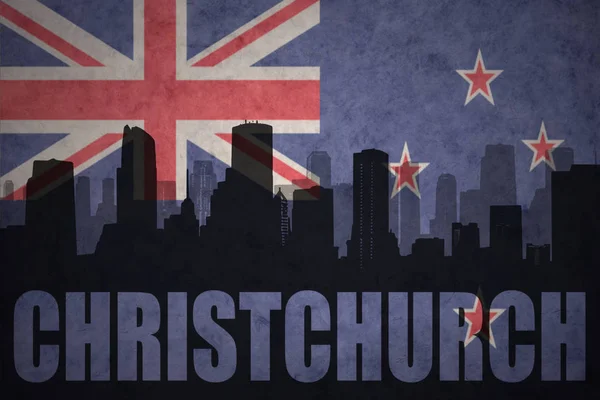 Abstract silhouette of the city with text Christchurch at the vintage new zealand flag — Stock Photo, Image