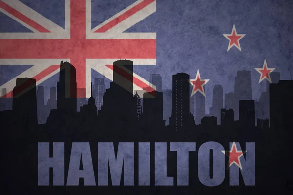 Abstract silhouette of the city with text Hamilton at the vintage new zealand flag — Stock Photo, Image