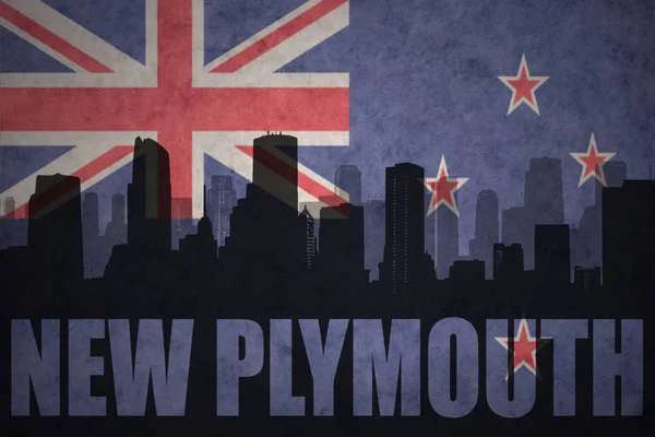 Abstract silhouette of the city with text New Plymouth at the vintage new zealand flag — Stock Photo, Image
