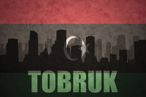 Özet metni Tobruk vintage Libya bayrağı ile şehir silüeti — Stok fotoğraf