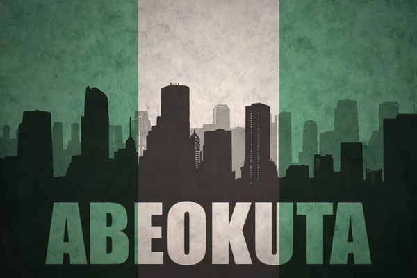 Metin Abeokuta, vintage Nijeryalı bayrağı ile şehrin soyut siluet — Stok fotoğraf