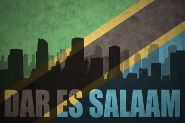 abstract silhouette of the city with text Dar es Salaam at the vintage tanzanian flag clipart