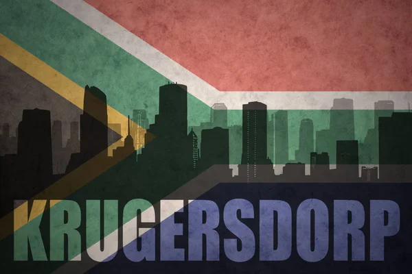 Abstracte silhouet van de stad met tekst Krugersdorp op de vintage vlag van Zuid-Afrika — Stockfoto
