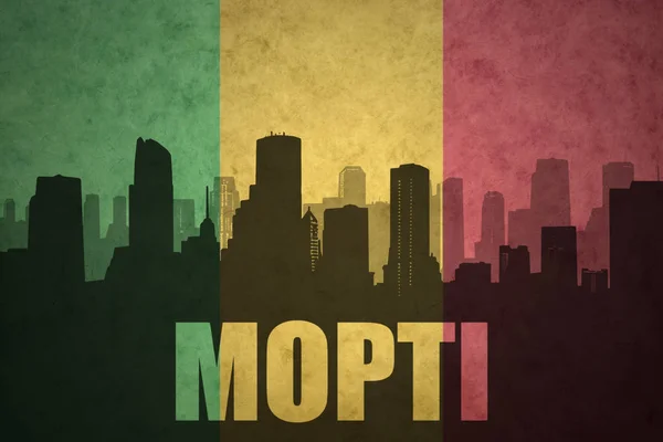 Silhouette astratta della città con testo Mopti alla bandiera maliana vintage — Foto Stock