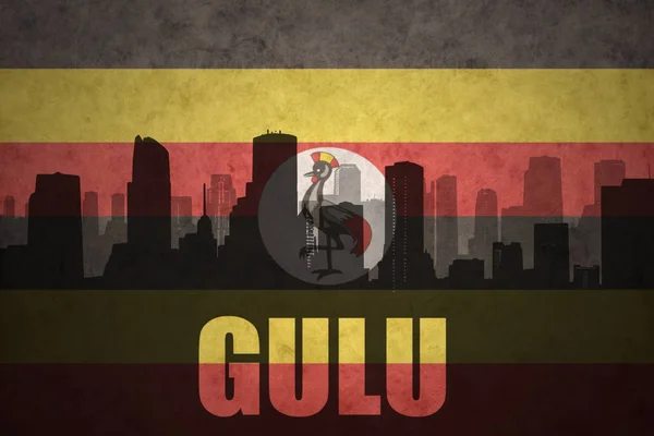 Streszczenie sylwetka miasta z tekstem Gulu w vintage flaga Ugandy — Zdjęcie stockowe