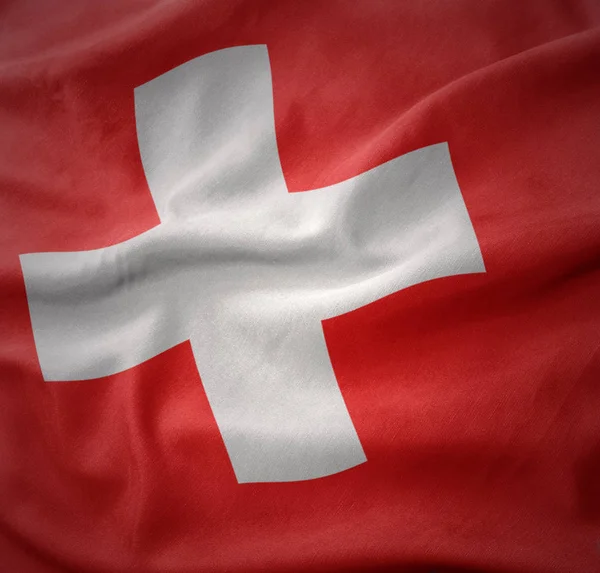 Mává barevná vlajka Švýcarska. — Stock fotografie