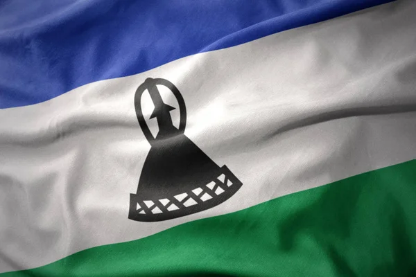 Renkli Lesoto bayrağı sallayarak. — Stok fotoğraf