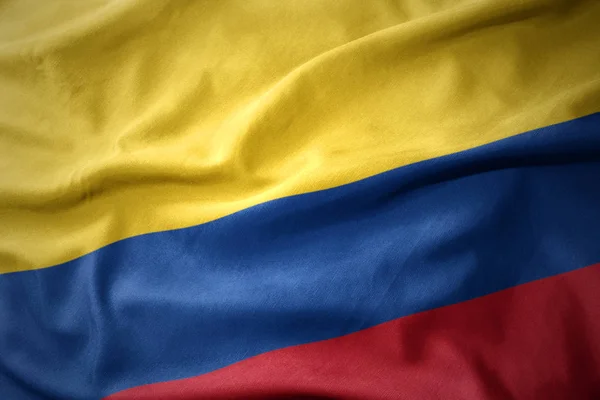 Viftar färgglada flagga i colombia. — Stockfoto