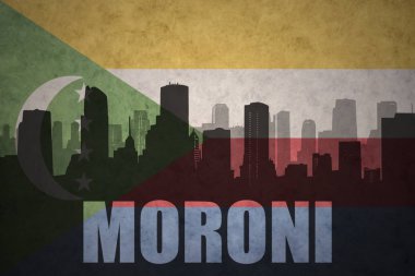 Özet metin moroni, vintage Komor bayrağı ile şehir silüeti