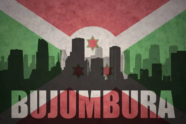 Streszczenie sylwetka miasta z bujumbura tekst o vintage flaga burundi — Zdjęcie stockowe