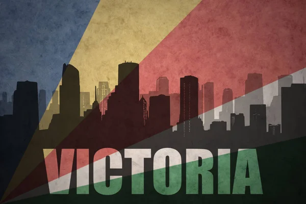 Abstract silhouette of the city with text victoria at the vintage seychelles flag — Stock Photo, Image