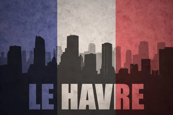 Abstract silhouette of the city with text Le Havre at the vintage french flag — Stock Photo, Image