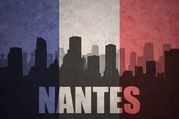 Abstracte silhouet van de stad met tekst Nantes op de vintage Franse vlag — Stockfoto