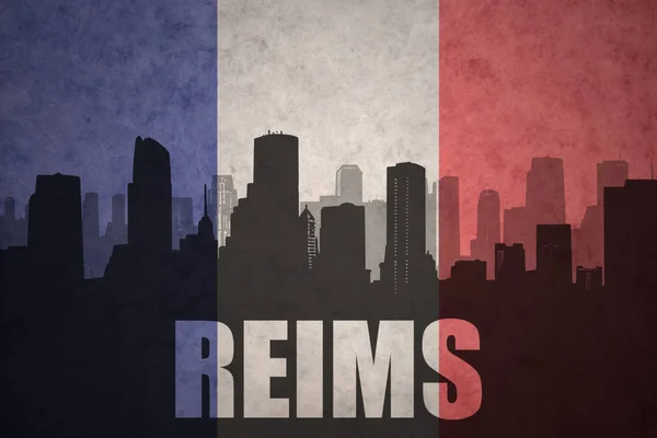 Абстрактный силуэт города с текстом Реймса на винтажном французском флаге — стоковое фото