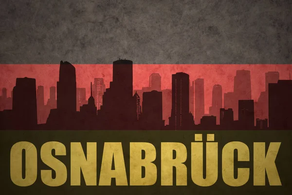 Abstrakte Silhouette der Stadt mit osnabruck-Text an der deutschen Fahne — Stockfoto