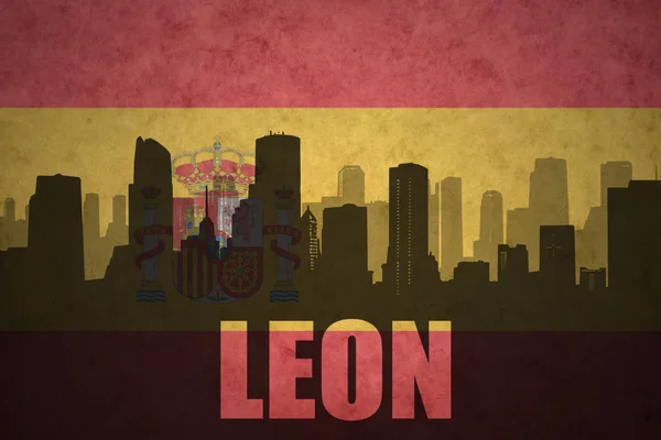 Abstrakta silhuetten av staden med text Leon på vintage spanska flaggan — Stockfoto