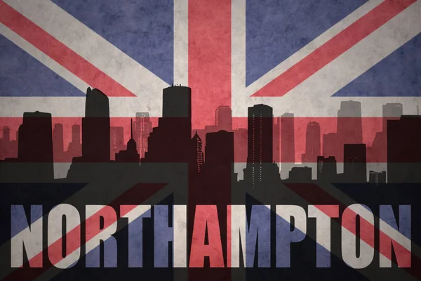 Abstraktní silueta města s textem Northampton na vintage britská vlajka — Stock fotografie