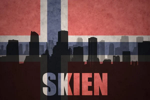 Abstract silhouette of the city with text Skien at the vintage norwegian flag — Stock Photo, Image