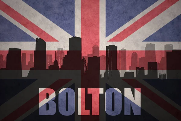 Abstract silhouette of the city with text Bolton at the vintage british flag — Stock Photo, Image