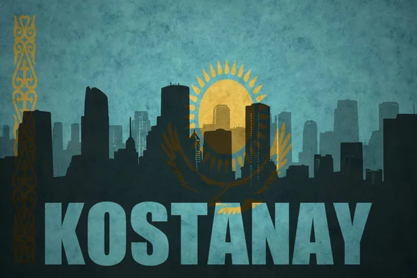 Abstraktní silueta města s textem Kostanay na vintage vlajka Kazachstánu — Stock fotografie