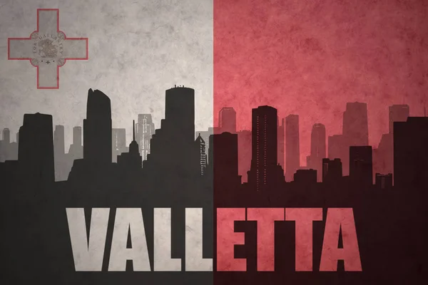 Abstracte silhouet van de stad met tekst valletta op vintage maltese vlag — Stockfoto