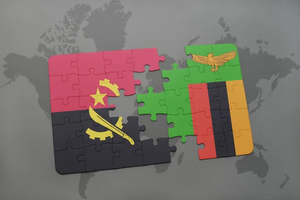 Puzzel met de nationale vlag van angola en zambia op een wereldkaart. — Stockfoto