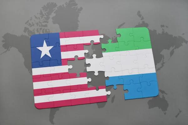 Puzzle s národní vlajkou Libérie a sierra leone na mapě světa — Stock fotografie