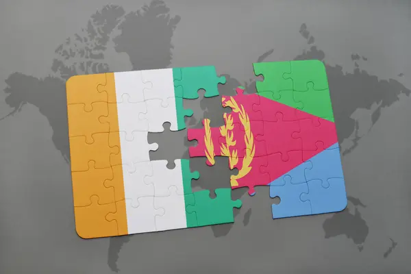 Puzzel met de nationale vlag van cote divoire en eritrea op een wereldkaart — Stockfoto