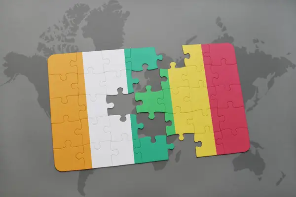 Puzzel met de nationale vlag van cote divoire en mali op een wereldkaart — Stockfoto
