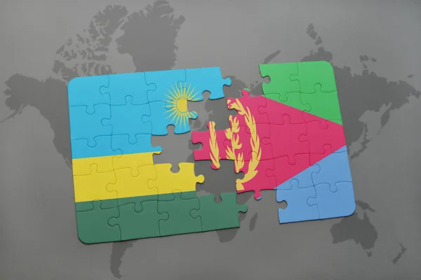 Puzzel met de nationale vlag van rwanda en eritrea op een wereldkaart — Stockfoto