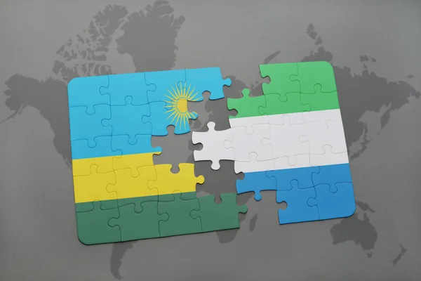 Quebra-cabeça com a bandeira nacional do Ruanda e sierra leone em um mapa do mundo — Fotografia de Stock