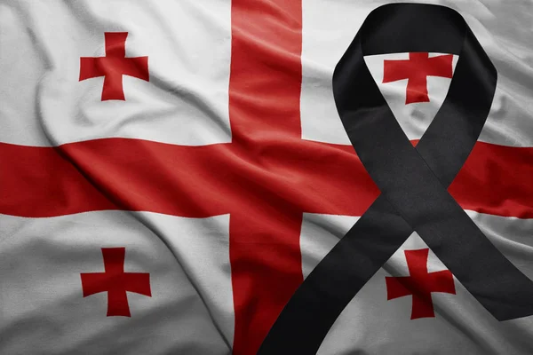 Flag of georgia with black mourning ribbon — Stock Photo, Image