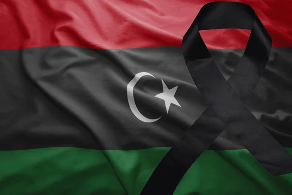 Flag of libya with black mourning ribbon — Stock Photo, Image