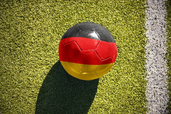 Fußball mit der deutschen Nationalflagge liegt auf dem Spielfeld — Stockfoto