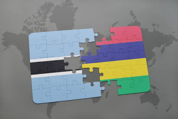 Puzzel met de nationale vlag van botswana en mauritius op een wereldkaart — Stockfoto