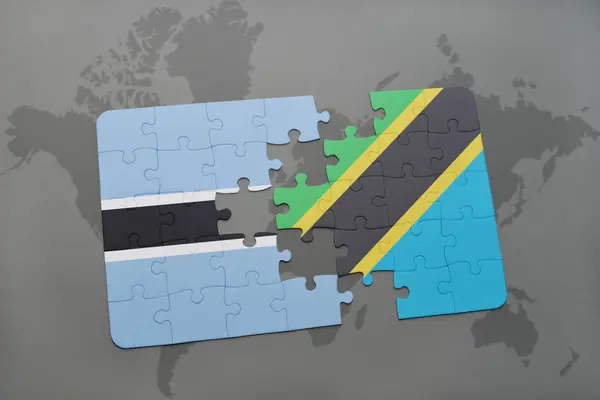 Puzzel met de nationale vlag van botswana en tanzania op een wereldkaart — Stockfoto